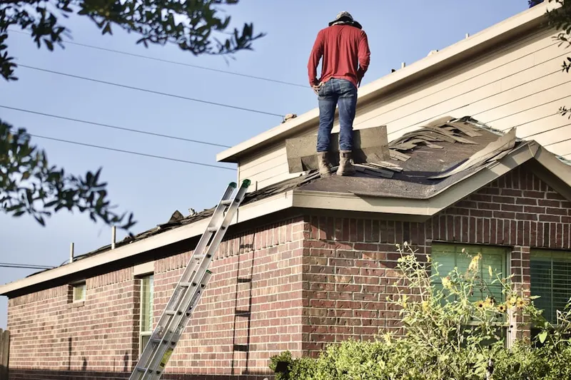 Professional roofer working on a residential roof in Wyomissing Park